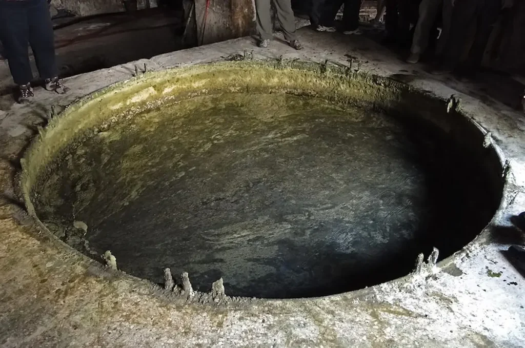 A view of the large traditional in-ground vats used for boiling olive and laurel oil during the ancient Aleppo soap-making process.
